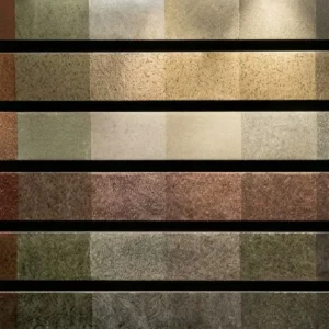 Develine Microcement color palette display showing rows of textured finish samples in earthy tones, warm terracottas, sage greens, and cool grays